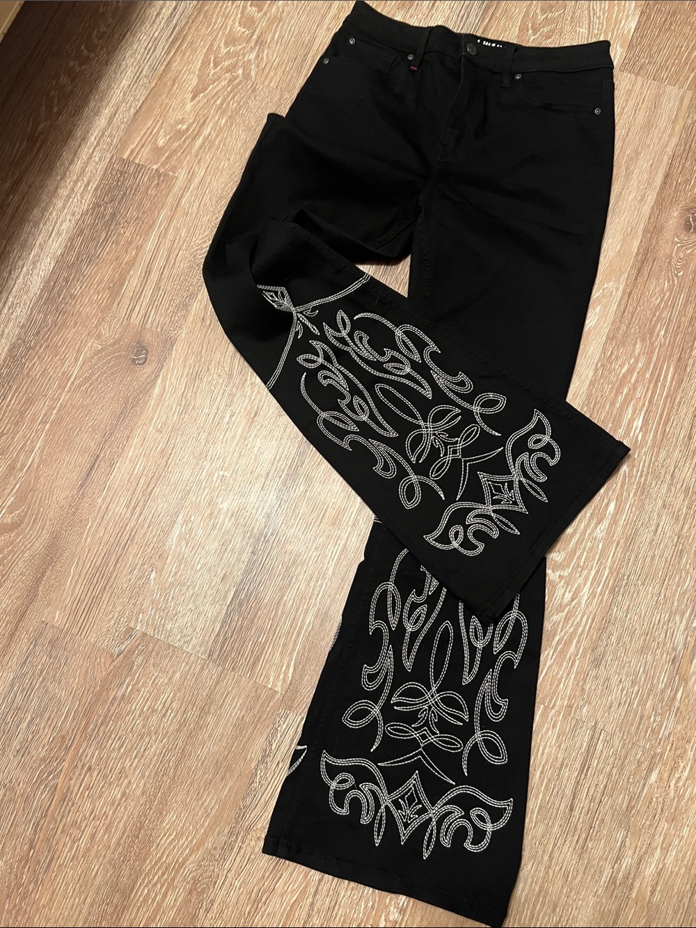 Black jeans with white embroidery stitching